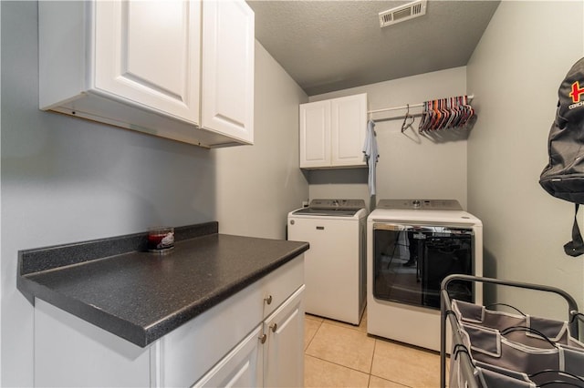 8266 Anna Maria Ave, Springdale, AR 72762 - laundry room featuring cabinet space, washing machine and clothes dryer, light tile patterned floors, and a textured ceiling