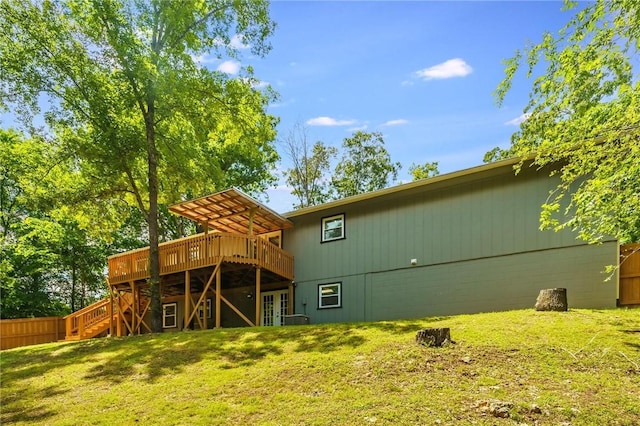 21 Chudleigh Ln, Bella Vista, AR 72714 - rear view of house with a wooden deck, french doors, a lawn, and stairs