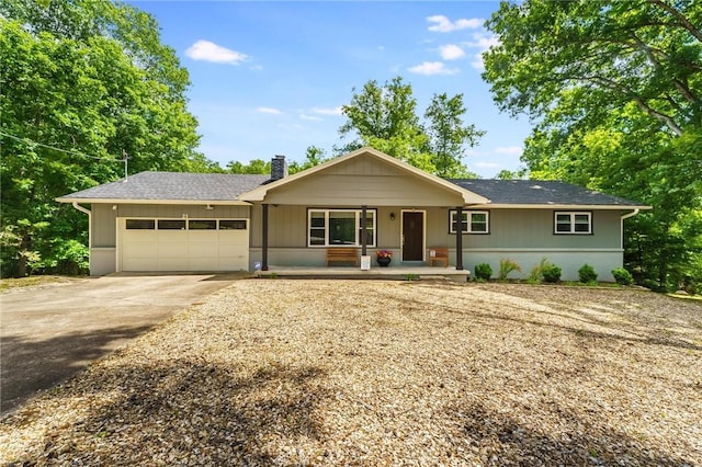21 Chudleigh Ln, Bella Vista, AR 72714 - ranch-style house with a garage, concrete driveway, covered porch, and a chimney