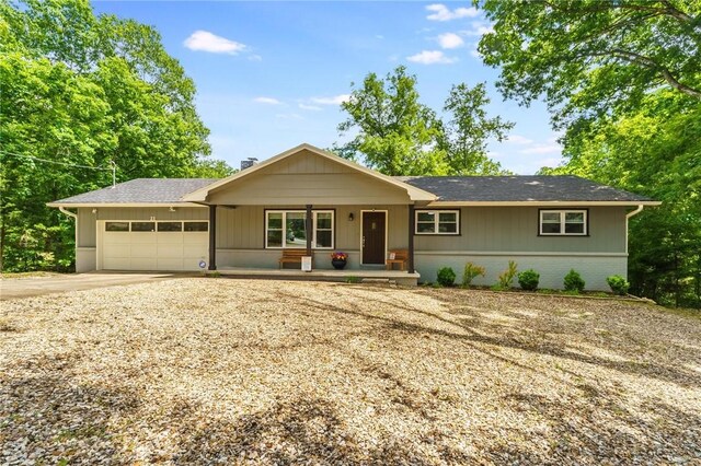 21 Chudleigh Ln, Bella Vista, AR 72714 - ranch-style home with an attached garage, a porch, concrete driveway, brick siding, and a shingled roof