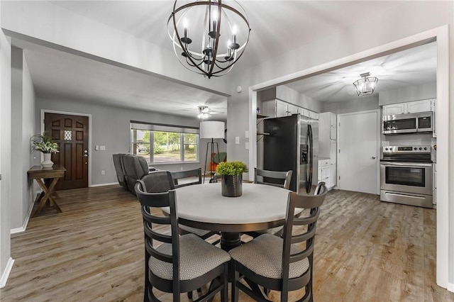21 Chudleigh Ln, Bella Vista, AR 72714 - dining room with a chandelier, light wood finished floors, and baseboards