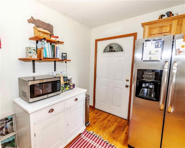518 W Aster Ave, Farmington, AR 72730 - kitchen featuring stainless steel appliances, light countertops, light wood-style flooring, open shelves, and white cabinetry