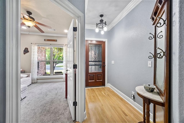 6645 Valley View Rd, Rogers, AR 72758 - foyer entrance featuring crown molding, baseboards, a chandelier, wood finished floors, and a textured wall
