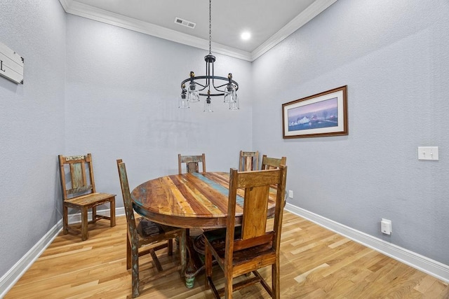 6645 Valley View Rd, Rogers, AR 72758 - dining space featuring crown molding, light wood finished floors, a chandelier, and baseboards