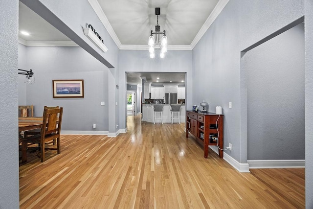 6645 Valley View Rd, Rogers, AR 72758 - foyer featuring light wood-type flooring, a chandelier, crown molding, and baseboards