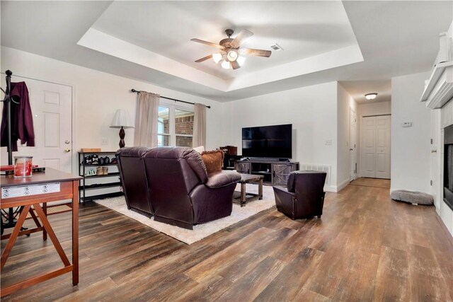 679 Richland Creek Ave, Elkins, AR 72727 - living room with a tray ceiling, wood finished floors, ceiling fan, and baseboards