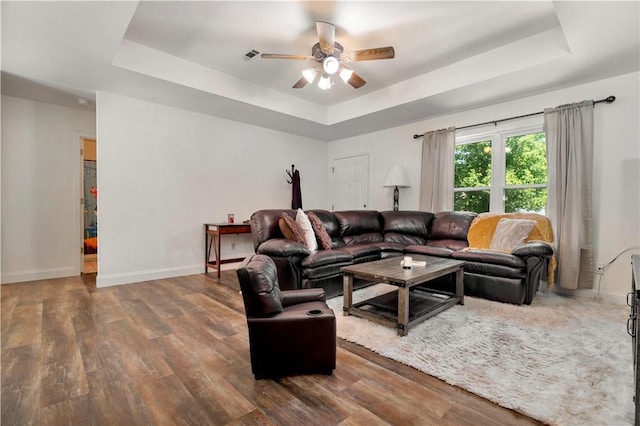 679 Richland Creek Ave, Elkins, AR 72727 - living area featuring a tray ceiling, a ceiling fan, wood finished floors, and baseboards