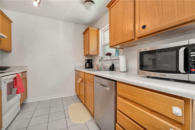 679 Richland Creek Ave, Elkins, AR 72727 - kitchen featuring appliances with stainless steel finishes, a sink, light countertops, baseboards, and light tile patterned flooring
