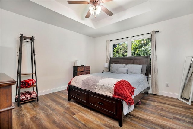 679 Richland Creek Ave, Elkins, AR 72727 - bedroom with a raised ceiling, dark wood-style floors, baseboards, and ceiling fan