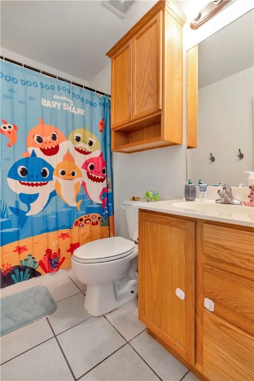 679 Richland Creek Ave, Elkins, AR 72727 - bathroom with toilet, vanity, tile patterned floors, and a shower with shower curtain