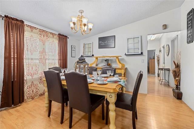 18246 Oakridge Rd, Springdale, AR 72764 - dining area featuring a chandelier, wood finished floors, and a textured ceiling