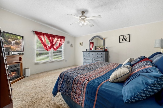 18246 Oakridge Rd, Springdale, AR 72764 - carpeted bedroom with a textured ceiling, ceiling fan, lofted ceiling, and a glass covered fireplace