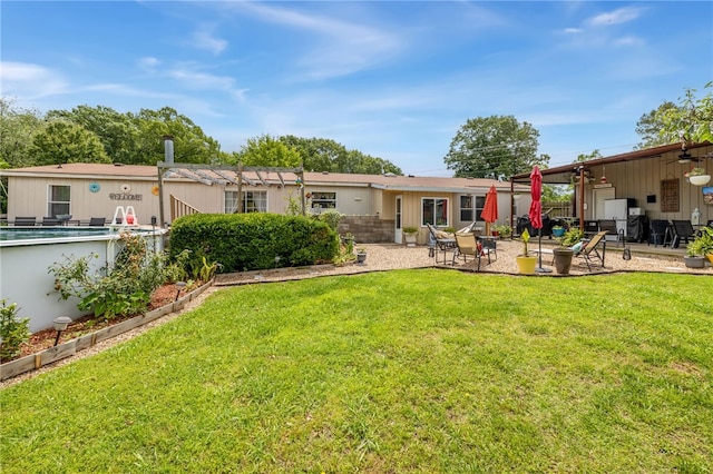 18246 Oakridge Rd, Springdale, AR 72764 - back of property with a patio area, ceiling fan, and a lawn