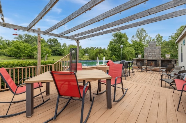 18246 Oakridge Rd, Springdale, AR 72764 - wooden terrace featuring an outdoor stone fireplace, outdoor dining space, a pergola, and view of wooded area