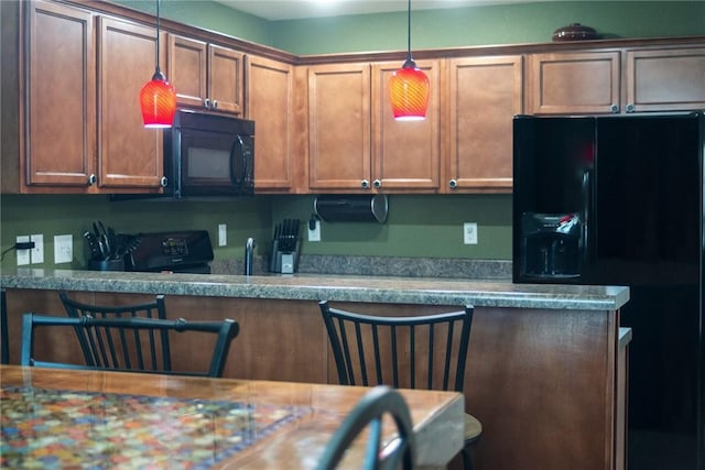 609 Buffalo Ln, Springdale, AR 72764 - kitchen featuring black appliances, hanging light fixtures, brown cabinetry, and a sink