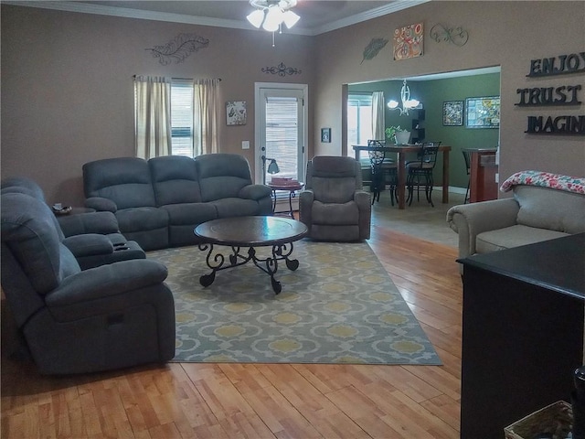 609 Buffalo Ln, Springdale, AR 72764 - living area with ornamental molding, a chandelier, plenty of natural light, ceiling fan, and wood finished floors