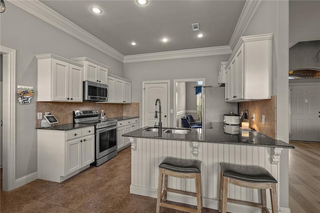 1021 Harvest St, Centerton, AR 72719 - kitchen featuring stainless steel appliances, a sink, a peninsula, white cabinets, and crown molding