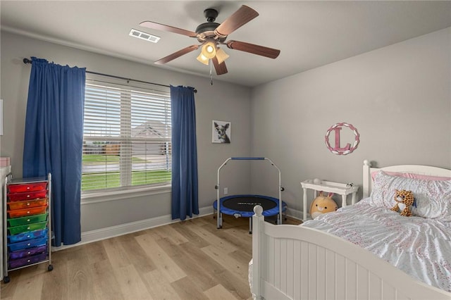 1021 Harvest St, Centerton, AR 72719 - bedroom with wood finished floors, baseboards, and ceiling fan