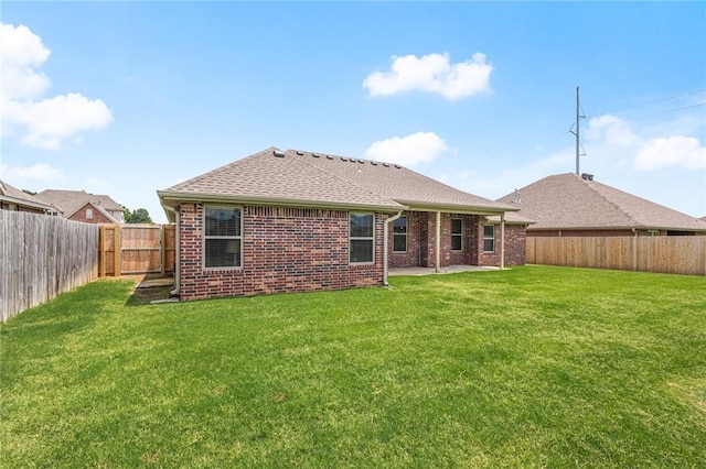 1021 Harvest St, Centerton, AR 72719 - rear view of house featuring brick siding, a patio area, and a shingled roof
