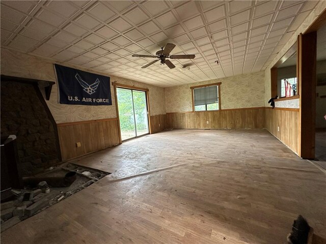 13888 White Oak Ln, Bentonville, AR 72712 - unfurnished living room with wainscoting, ceiling fan, wood walls, and wood finished floors