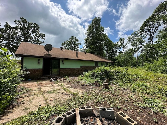 13888 White Oak Ln, Bentonville, AR 72712 - view of front of home with a vegetable garden and brick siding