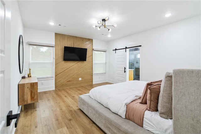 204 NE Healing Springs St, Bentonville, AR 72713 - bedroom with a barn door, baseboards, light wood-type flooring, recessed lighting, and a chandelier