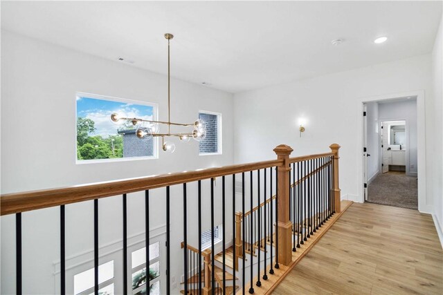 204 NE Healing Springs St, Bentonville, AR 72713 - hallway featuring an upstairs landing, light wood finished floors, recessed lighting, a chandelier, and baseboards