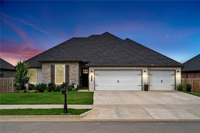 2009 Abbott Ln, Pea Ridge, AR 72751 - view of front facade featuring a garage, driveway, a shingled roof, and stone siding