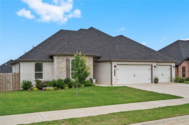 2009 Abbott Ln, Pea Ridge, AR 72751 - french country style house featuring an attached garage, driveway, a shingled roof, and brick siding