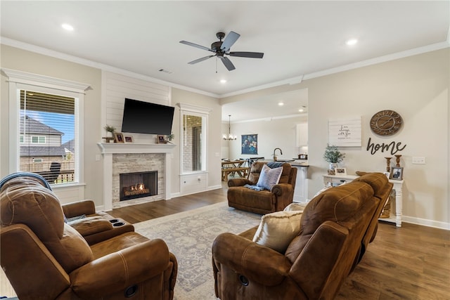 2009 Abbott Ln, Pea Ridge, AR 72751 - living room with ceiling fan, dark wood-style floors, a fireplace, ornamental molding, and recessed lighting