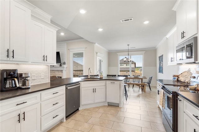 2009 Abbott Ln, Pea Ridge, AR 72751 - kitchen featuring stainless steel appliances, dark countertops, crown molding, tasteful backsplash, and white cabinets