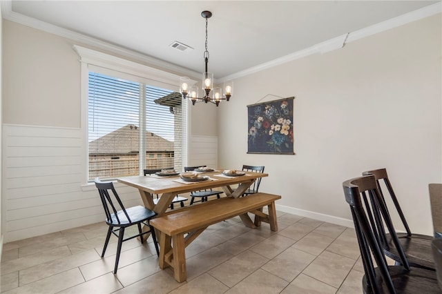 2009 Abbott Ln, Pea Ridge, AR 72751 - dining area with a chandelier, crown molding, light tile patterned floors, wainscoting, and wooden walls