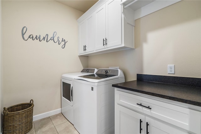 2009 Abbott Ln, Pea Ridge, AR 72751 - laundry area featuring cabinet space, washing machine and clothes dryer, and light tile patterned floors