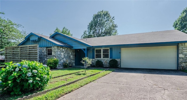 1608 Cartwright Cir, Springdale, AR 72762 - ranch-style home featuring stone siding, an attached garage, and driveway