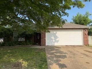 1210 Apache Dr, Bentonville, AR 72712 - view of front of property featuring brick siding, driveway, and an attached garage