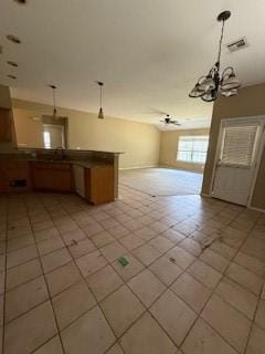 1210 Apache Dr, Bentonville, AR 72712 - kitchen featuring a chandelier, decorative light fixtures, a peninsula, light tile patterned floors, and open floor plan