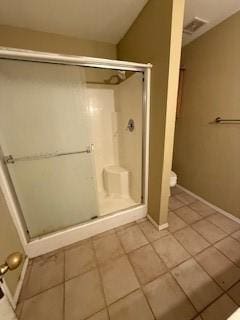 1210 Apache Dr, Bentonville, AR 72712 - bathroom featuring tile patterned floors, a shower stall, baseboards, and toilet