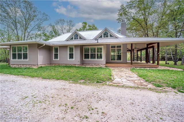 19643 Indigo Dr, Rogers, AR 72756 - view of front of house with a chimney, metal roof, and a front yard