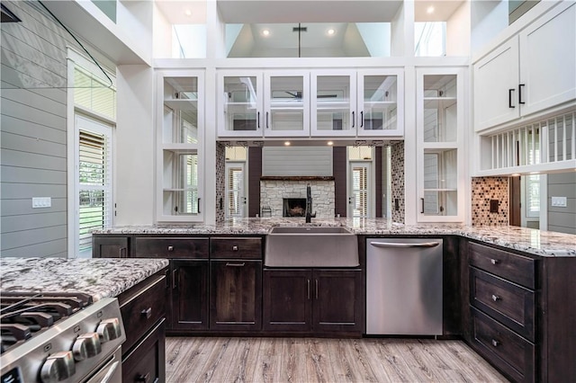 19643 Indigo Dr, Rogers, AR 72756 - kitchen featuring stainless steel appliances, white cabinets, a sink, glass insert cabinets, and recessed lighting