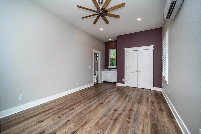 19643 Indigo Dr, Rogers, AR 72756 - unfurnished bedroom with a wall unit AC, wood finished floors, baseboards, recessed lighting, and a closet