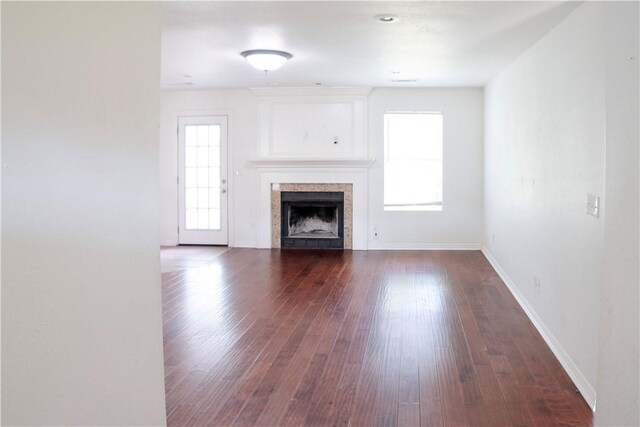 19105 Feather Hill Rd, Elkins, AR 72727 - unfurnished living room featuring hardwood / wood-style floors, baseboards, and a tiled fireplace