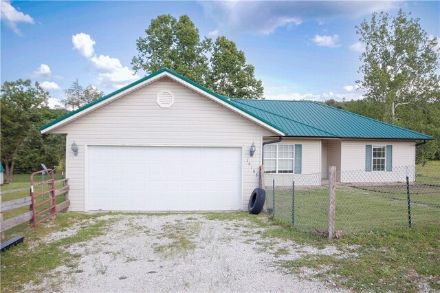 19105 Feather Hill Rd, Elkins, AR 72727 - single story home with metal roof, driveway, and an attached garage