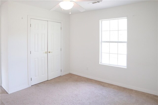 19105 Feather Hill Rd, Elkins, AR 72727 - unfurnished bedroom with carpet floors, a closet, baseboards, and a ceiling fan