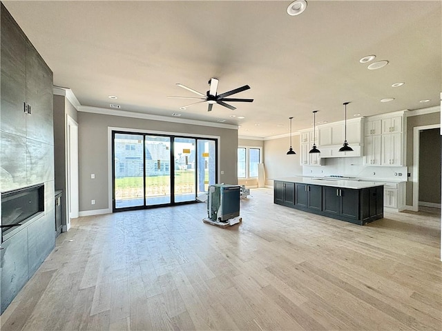 6702 SW Brilliance Ter, Bentonville, AR 72713 - unfurnished living room featuring ornamental molding, a ceiling fan, recessed lighting, light wood finished floors, and baseboards