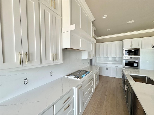 6702 SW Brilliance Ter, Bentonville, AR 72713 - kitchen featuring stainless steel appliances, white cabinetry, light wood finished floors, crown molding, and recessed lighting