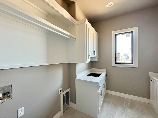 6702 SW Brilliance Ter, Bentonville, AR 72713 - laundry room featuring cabinet space, electric dryer hookup, and baseboards