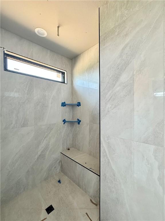6702 SW Brilliance Ter, Bentonville, AR 72713 - bathroom featuring a tile shower