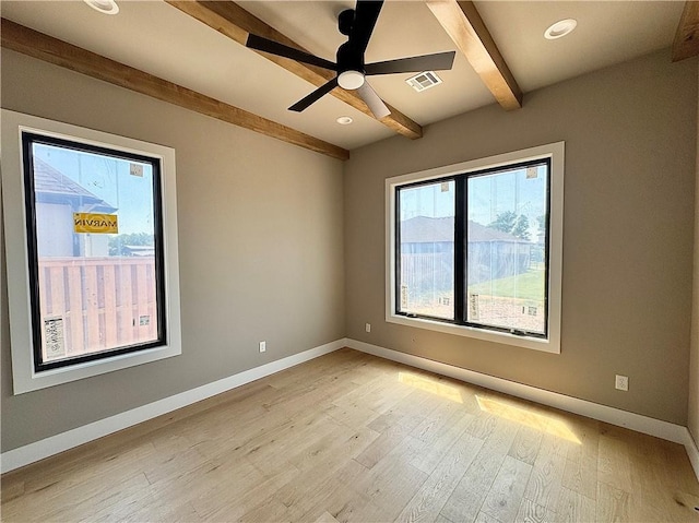 6702 SW Brilliance Ter, Bentonville, AR 72713 - empty room with beamed ceiling, healthy amount of natural light, light wood finished floors, baseboards, and recessed lighting