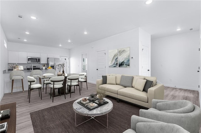 841 States Ave, Bentonville, AR 72713 - living area with recessed lighting, light wood-style flooring, and baseboards