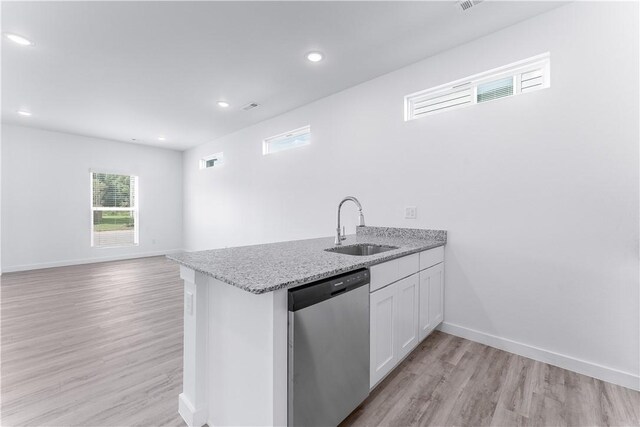 841 States Ave, Bentonville, AR 72713 - kitchen featuring stainless steel dishwasher, a sink, white cabinets, light wood-style floors, and light stone countertops